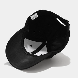 Black crown embroidery baseball cap interior view with 100% acrylic care label and adjustable strap