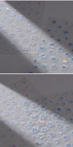 Macro shot of M-576 holographic cherry blossom nail stickers with iridescent floral patterns