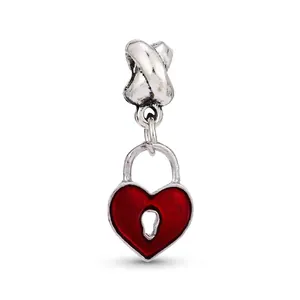 Macro shot of silver heart lock charm with red enamel and keyhole for charm bracelets