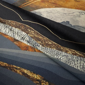 Detailed macro shot showing woven texture and abstract mountain design of the wall tapestry