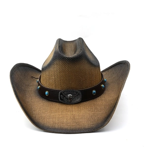 Detail of western straw hat featuring turquoise beads and a metal bull head buckle