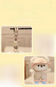 Detail of cute teddy bear plush keychain with handmade hat and woven strap attachment