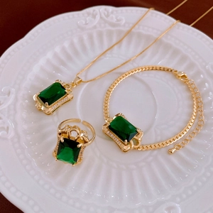 Macro shot of green zircon square jewelry set including necklace, bracelet and ring