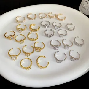 Adjustable geometric heart zircon ring set in gold and silver finish on white tray