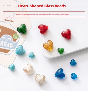 Macro detail of heart-shaped glass beads with gold foil foil interior for DIY jewelry