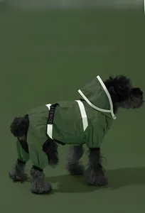 Detail of dark green dog raincoat with white reflective strips and waterproof hood