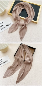 Detailed view of champagne pleated square scarf with elegant accordion fold texture
