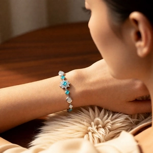 Close-up of vintage flower zircon bracelet with sky blue gemstones on woman wrist
