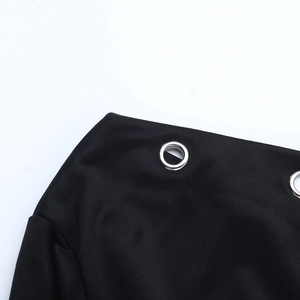 Detail of silver metal eyelets on premium black fabric with smooth textile texture