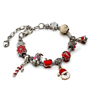Adjustable Christmas charm bracelet with snowman and Santa pendants on white background