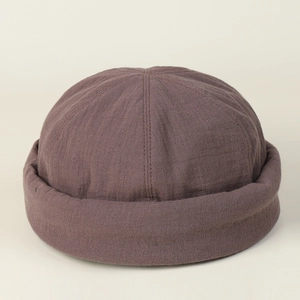 Detail of street style docker cap in dark brown textured cotton with rolled brim edge