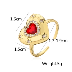 Detail view of 18K gold plated copper ring with red zircon heart and star accents
