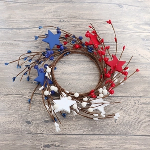 Detail of 4th of July candle ring with red white blue stars and berry accents