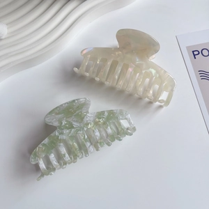 Set of two colorful acetate hair claws in pearly white and marble green patterns