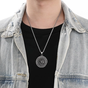 Male model wearing vintage silver Viking wolf pendant necklace with Nordic runes and chain
