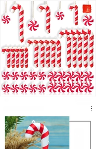 Close-up of red and white candy cane ornaments with Merry Christmas ribbons on pine branches
