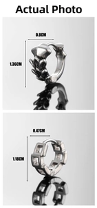 Detail view of gothic feather and geometric chain link stainless steel huggie earrings