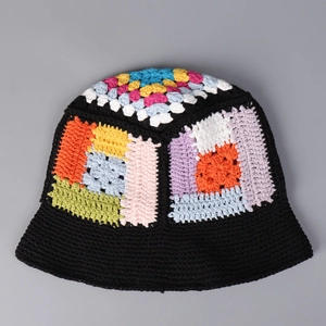 Close-up of handmade crochet bucket hat with colorful granny square patterns and knit texture