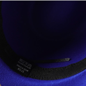 Macro shot of fedora hat inner lining showing 100% polyester label and 57cm size tag
