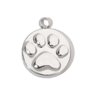 Macro view of a polished stainless steel round charm with an engraved pet paw print design