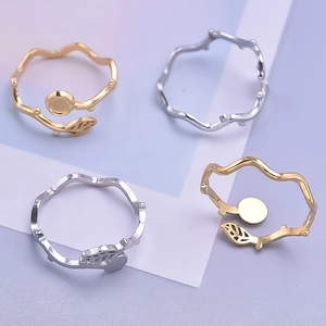 Detailed close-up of adjustable leaf and branch rings in gold and silver steel finish