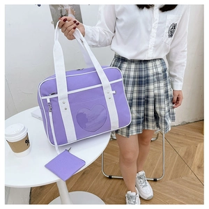 Detail of purple JK uniform bag featuring a heart-shaped window and a matching coin purse