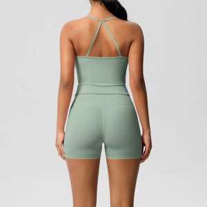 Close-up of the cross-back sports bra and high-waist shorts in sage green fabric