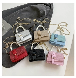 Detailed top view of six stylish glitter mini bags with pearl handles and chain straps