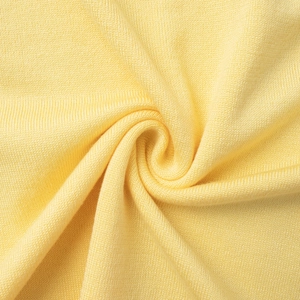 Detail of pale yellow knit fabric showing soft texture and premium spiral weave detail