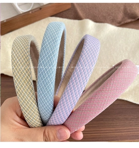 Detail of colorful woven sponge headbands with thick mesh texture and non-slip lining