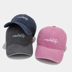 Three washed cotton momlife baseball caps in navy blue, dark grey, and pink colors