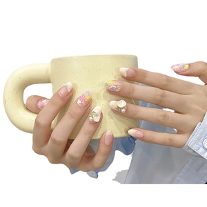 Handmade press-on nails with 3D floral petals, pearls, and golden bow decoration