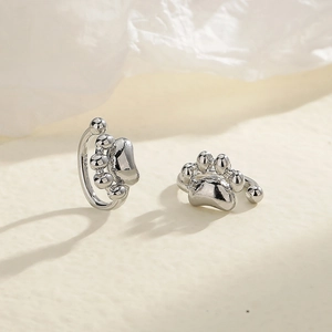 Detail view of S925 sterling silver cat paw ear cuffs showing the polished texture and stamp