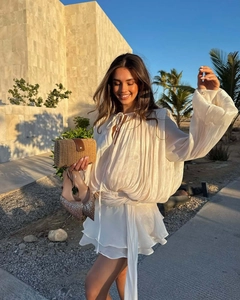 White chiffon tie-front top and layered mini skirt with straw clutch in desert sunset