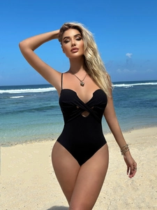 Detail shot of black ribbed cut-out one-piece swimsuit with front cross knot design