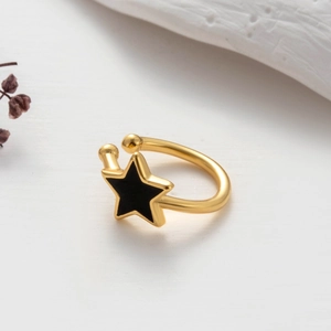 Golden cartilage ear cuff with black star pattern, minimalist clip-on earring for women