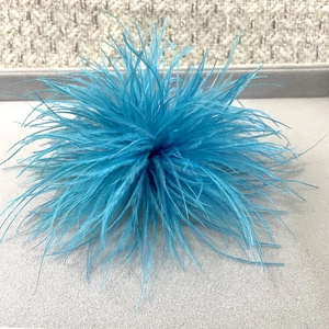 Macro shot of fluffy bright blue ostrich feather brooch with detailed texture