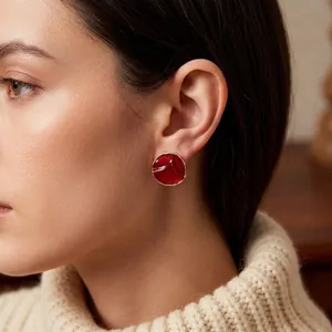 Vintage dark red round enamel stud earrings with gold edges and textured surface
