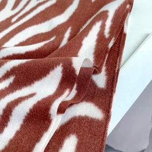 Close-up of soft brown and white zebra striped cashmere fabric texture and weave details