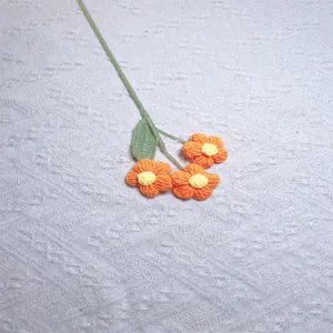 Detailed view of handmade crochet orange puff flowers with soft knitted wool texture