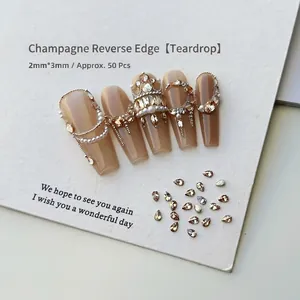 Detailed view of 2x3mm champagne teardrop nail art rhinestones with high sparkle effect