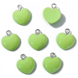 Group of seven green heart-shaped resin charms with metal rings for DIY jewelry making