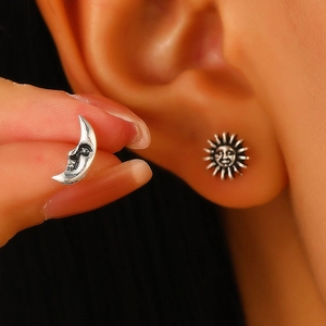Retro silver sun and moon stud earrings featuring human face details in a C-shape design