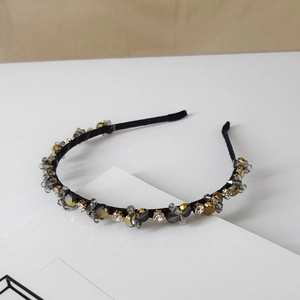 Close-up of luxury black fabric headband with multi-color crystal beads and rhinestones
