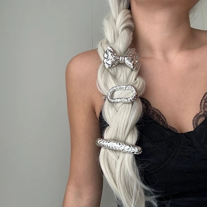 Three-piece silver hammered metal hair accessories set on white braided hair display