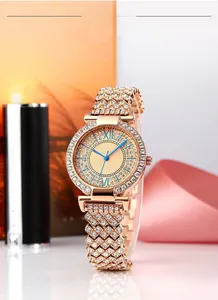 Close-up of luxury women's rose gold watch with sparkling rhinestones and blue roman numerals