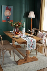 Detail of Christmas table runner with reindeer print and matching holiday pillows