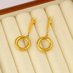 Macro shot of 18K gold plated hoop earrings with embossed texture on velvet