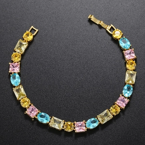 Detail of gold-plated brass bracelet with multi-color claw-set cubic zirconia stones