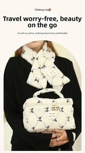 Detail of white sherpa makeup bag with bow pattern and matching scarf set